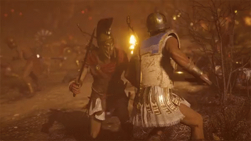 A Man Is Holding A Sword In The Desert GIF