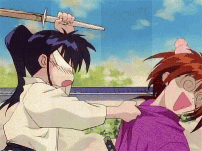 A Man Is Holding A Sword Over Another Man 'S Head . GIF