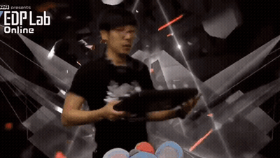 A Man Is Holding A Tablet In Front Of A Screen That Says Edplab Online GIF