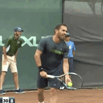 A Man Is Holding A Tennis Racquet On A Court With The Number 30 On The Bottom GIF