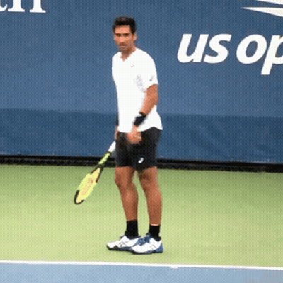 A Man Is Holding A Tennis Racquet On A Tennis Court In Front Of A Banner That Says Us Open GIF