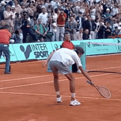 A Man Is Holding A Tennis Racquet On A Tennis Court In Front Of A Sign That Says Inter Sport GIF
