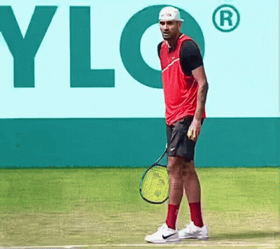 A Man Is Holding A Tennis Racquet On A Tennis Court In Front Of A Sign That Says Ylg GIF