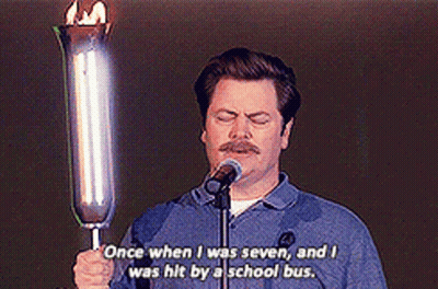 A Man Is Holding A Torch In Front Of A Microphone And Says Once When I Was Seven GIF