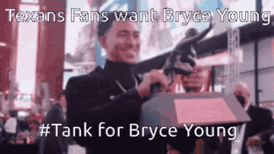 A Man Is Holding A Trophy In Front Of A Crowd And Says Texans Fans Want Bryce Young GIF