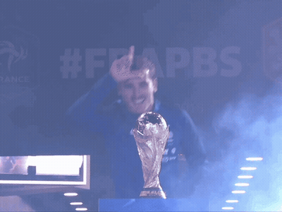 A Man Is Holding A Trophy In Front Of A Sign That Says #Frappbs GIF