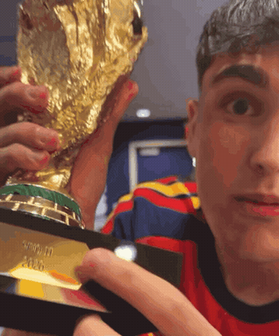 A Man Is Holding A Trophy That Says ' Fifa ' On It GIF