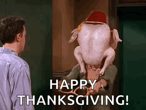 A Man Is Holding A Turkey With A Hat On Its Head And Says `` Happy Thanksgiving '' . GIF