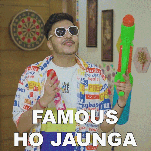 A Man Is Holding A Water Gun And Says Famous Ho Jaunga GIF