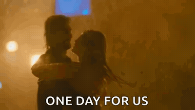 A Man Is Holding A Woman In His Arms And The Words `` One Day For Us '' Are Written Above Them . GIF