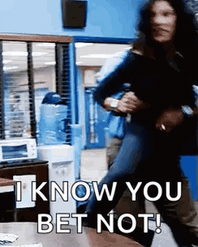 A Man Is Holding A Woman In His Arms In A Room And Says `` I Know You Bet Not '' . GIF