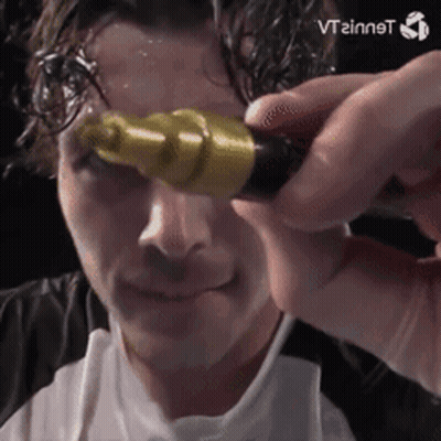 A Man Is Holding A Yellow Object In Front Of His Face And The Word Vtzinnst Is Visible In The Corner GIF