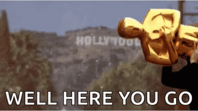 A Man Is Holding An Oscar Statue In Front Of A Sign That Says Hollywood GIF