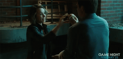 A Man Is Holding Another Man 'S Hand In A Scene From Game Night GIF