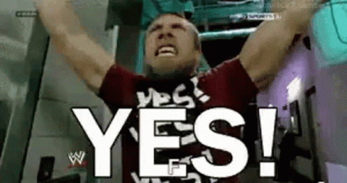 A Man Is Holding His Arms Up In The Air And Saying Yes . GIF