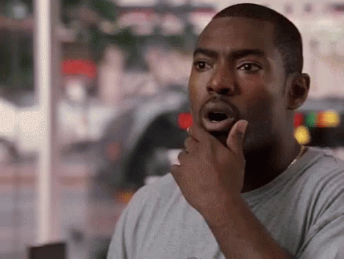 A Man Is Holding His Hand To His Chin And Making A Funny Face . GIF