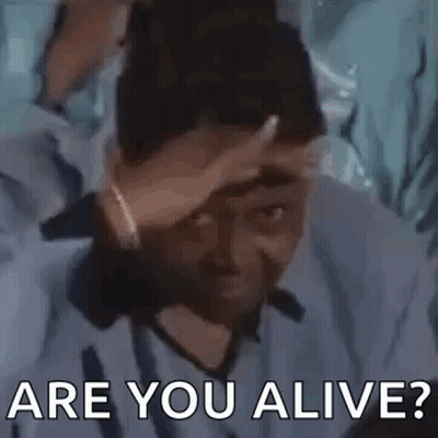 A Man Is Holding His Hand To His Forehead And Asking Are You Alive . GIF