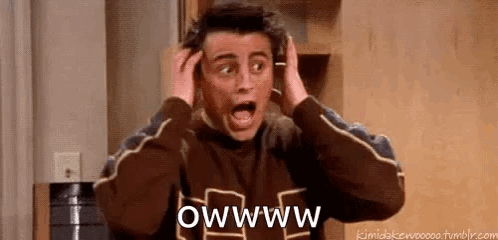 A Man Is Holding His Head With His Hands While Making A Surprised Face . GIF