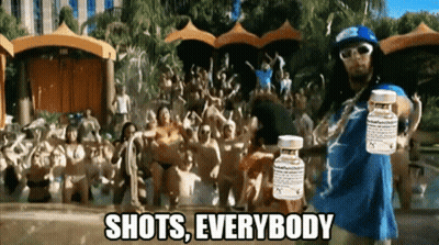 A Man Is Holding Two Bottles Of Pills In Front Of A Crowd And The Caption Shots Everybody GIF