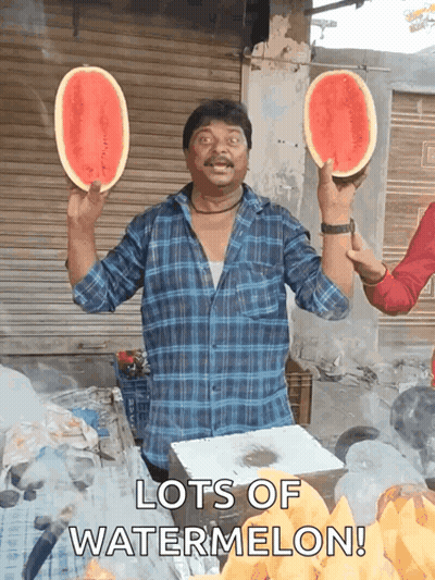 A Man Is Holding Two Slices Of Watermelon In His Hands With The Words Lots Of Watermelon Below Him GIF