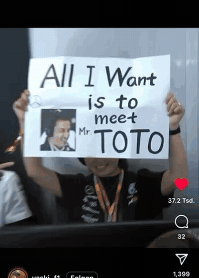 A Man Is Holding Up A Sign That Says All I Want Is To Meet Mr. Toto GIF