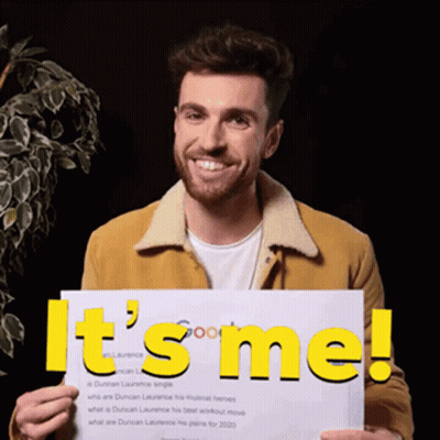 A Man Is Holding Up A Sign That Says It 'S Me GIF