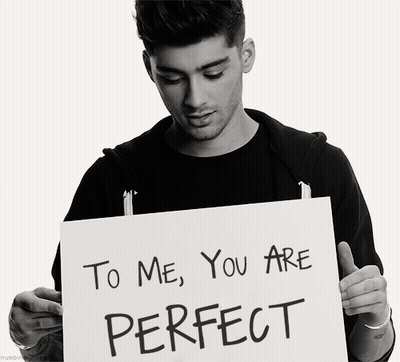 A Man Is Holding Up A Sign That Says To Me You Are Perfect GIF