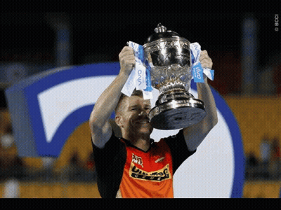 A Man Is Holding Up A Trophy That Says Vivo GIF