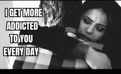 A Man Is Hugging A Woman In A Black And White Photo With The Caption `` I Get More Addicted To You Every Day '' . GIF