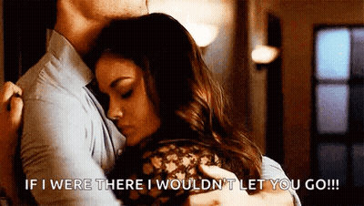 A Man Is Hugging A Woman With The Words `` If I Were There I Wouldn 'T Let You Go '' GIF