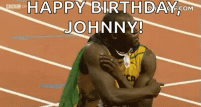 A Man Is Hugging Another Man On A Track And Says `` Happy Birthday Johnny ! '' GIF