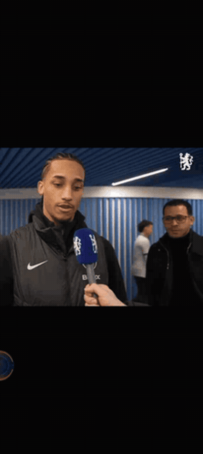 A Man Is Hugging Another Man While Holding A Microphone That Says Cbs On It GIF