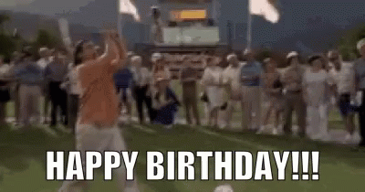 A Man Is Jumping In The Air In Front Of A Crowd While Holding A Microphone And Saying `` Happy Birthday ! '' GIF
