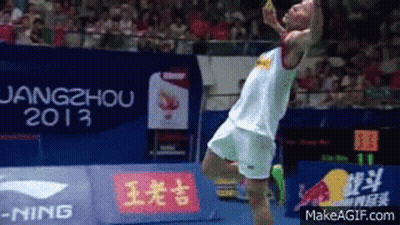 A Man Is Jumping In The Air In Front Of A Sign That Says 2013 GIF