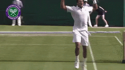 A Man Is Jumping In The Air On A Tennis Court In Front Of A Logo For The Wimbledon Championships GIF