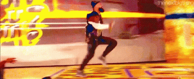 A Man Is Jumping In The Air While Holding A Basketball . GIF