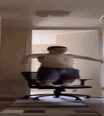 A Man Is Jumping In The Air While Sitting On A Chair . GIF