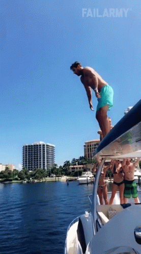 A Man Is Jumping Off The Side Of A Boat With Failarmy In The Corner GIF