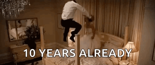 A Man Is Jumping On Top Of A Bed With A Bride . GIF