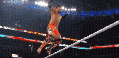 A Man Is Jumping Over A Rope During A Wrestling Match GIF