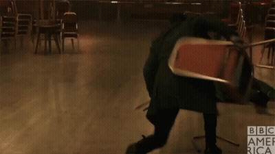 A Man Is Kicking A Chair In A Room With Bbc America Written On The Bottom Right GIF