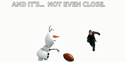 A Man Is Kicking A Football Towards A Snowman . GIF