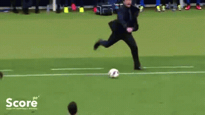 A Man Is Kicking A Soccer Ball On A Field With The Word Score On The Bottom Left GIF