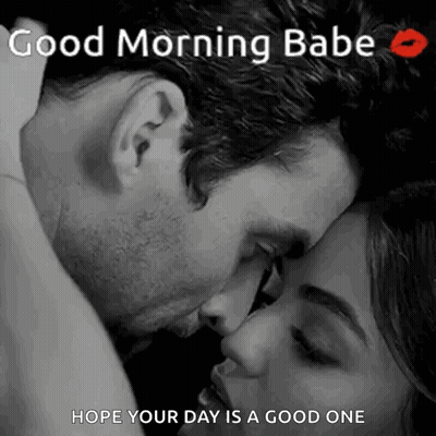 A Man Is Kissing A Woman On The Forehead . GIF
