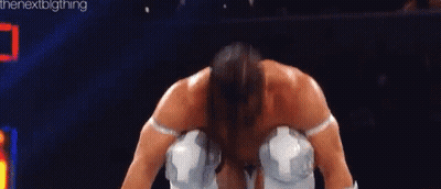 A Man Is Kneeling Down In A Boxing Ring Wearing White Gloves And Knee Pads . GIF