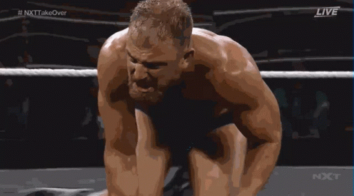 A Man Is Kneeling Down In A Wrestling Ring With The Words Live On The Bottom Right GIF