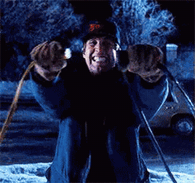 A Man Is Kneeling Down In The Snow Holding A Pair Of Skis GIF
