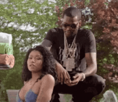 A Man Is Kneeling Down Next To A Woman In A Blue Bra . GIF
