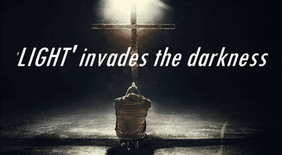 A Man Is Kneeling In Front Of A Cross With The Words Light Invades The Darkness Above Him GIF
