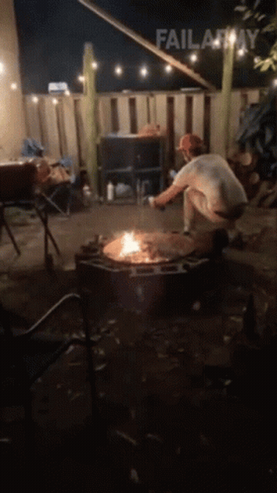 A Man Is Kneeling In Front Of A Fire Pit With Failarmy Written Above Him GIF
